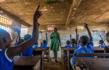 Patience Ado-Asquoah, health and hygiene teacher, instructs her classroom on personal hygiene practices at the Kade Presbyterian School, Kade, Ghana. 25 June 2019. Rotarians from 35 clubs across the country are partnering with USAID and national and local agencies of the government of Ghana in a large-scale $4 million program in water, sanitation and hygiene serving 75,000 people. By working together, both partners leverage each other strengths for more sustainable impact in improving access to clean water and sanitation services, fostering the adoption of hygiene behavior, strengthen community management systems, and influencing decision makers for prioritized financing of local water and sanitation services. Find the story in "The Rotarian," December 2019.